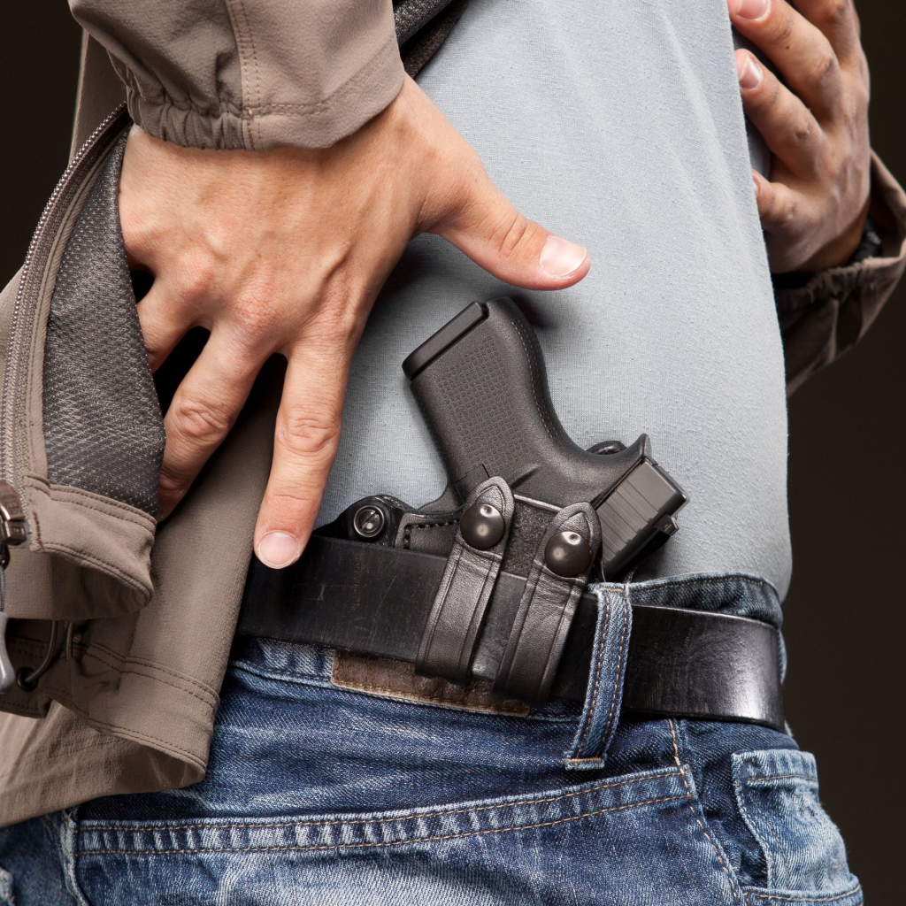 man drawing from a waistband holster